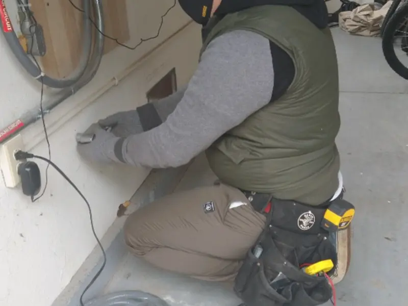 Electrician performing outlet wiring in a Streetsboro garage